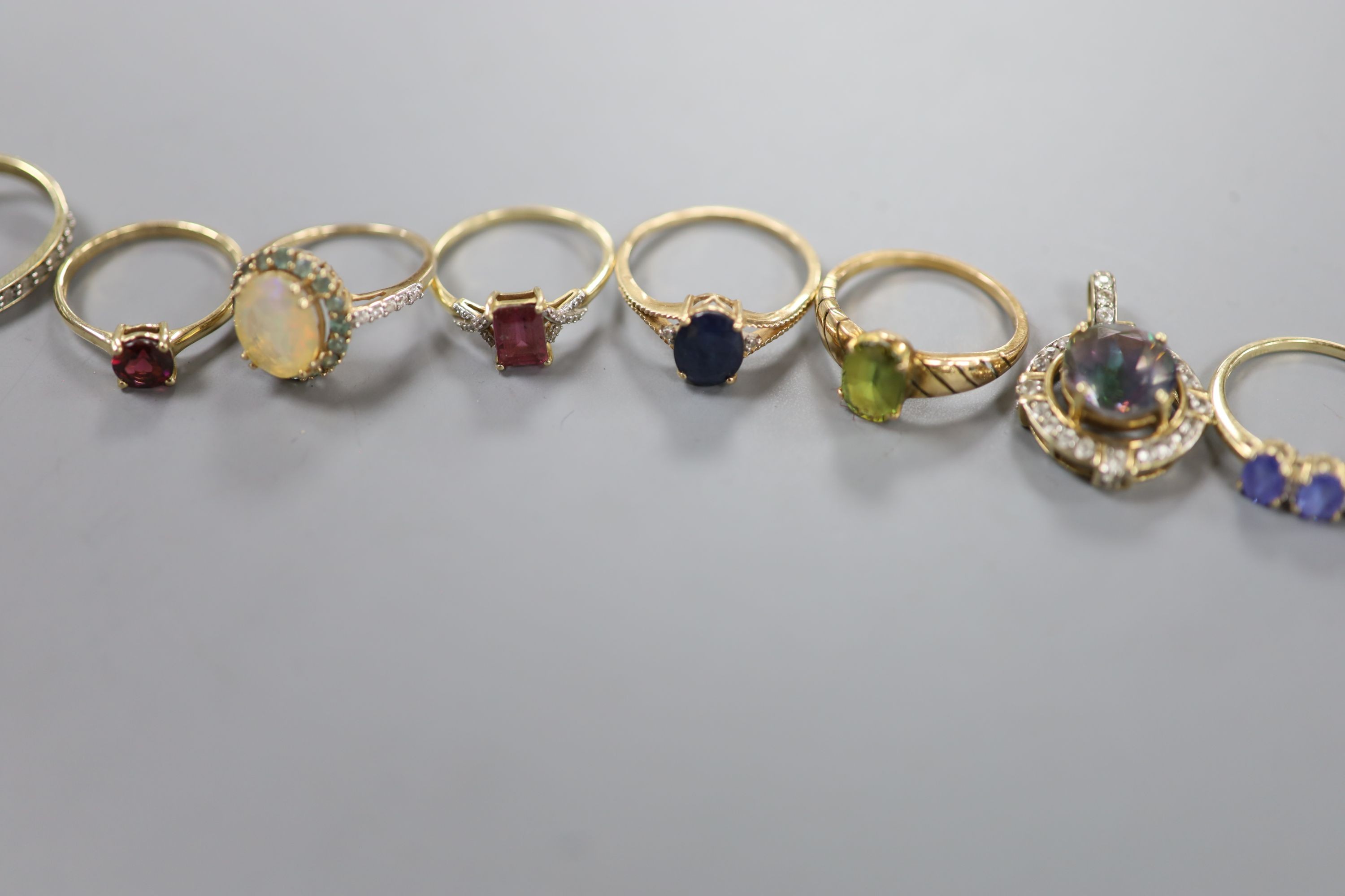 Six assorted modern 9ct gold and gem set dress rings, a pair of 9ct and gem set earrings and two 9ct gold and gem set pendants, gross weight 22.2 grams, a yellow metal and olivine? ring, gross 3.7 grams and a pair of 925
